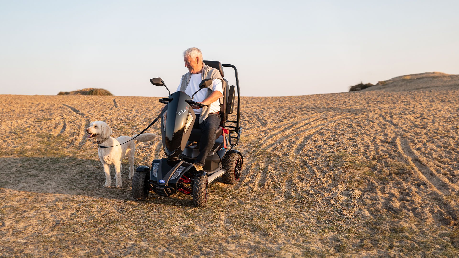 Man on a mobility scooter walking his dog in the UK hills