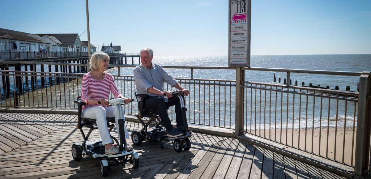 A couple on their Minimo and Minimo Plus folding mobility scooters