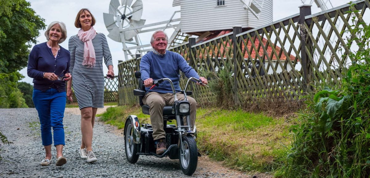 An older man using a Supersport off road mobility scooter